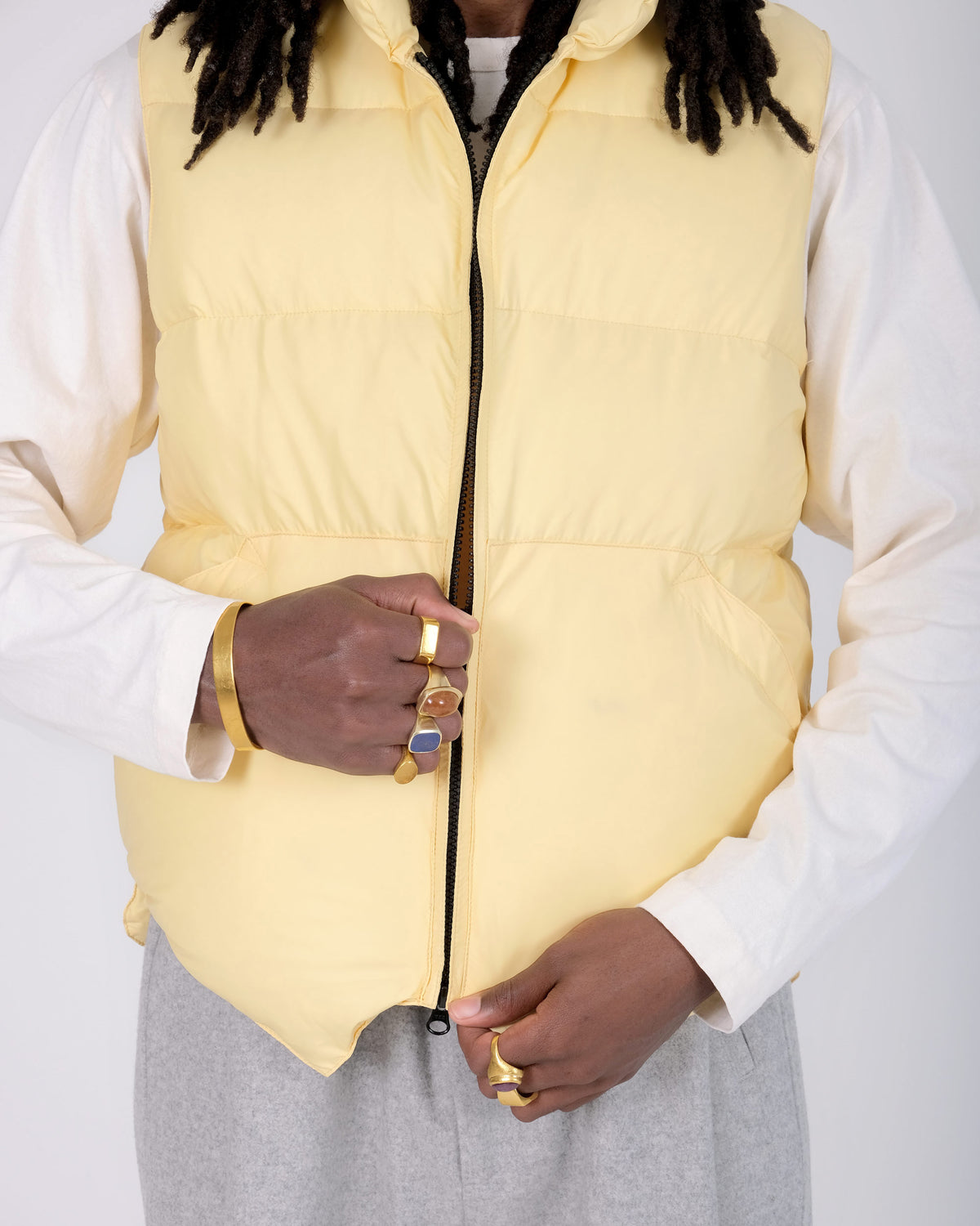 Front closeup view of a model wearing the Crescent Down Works &quot;Sun&quot; colorway of the Down North by Northwest vest. 