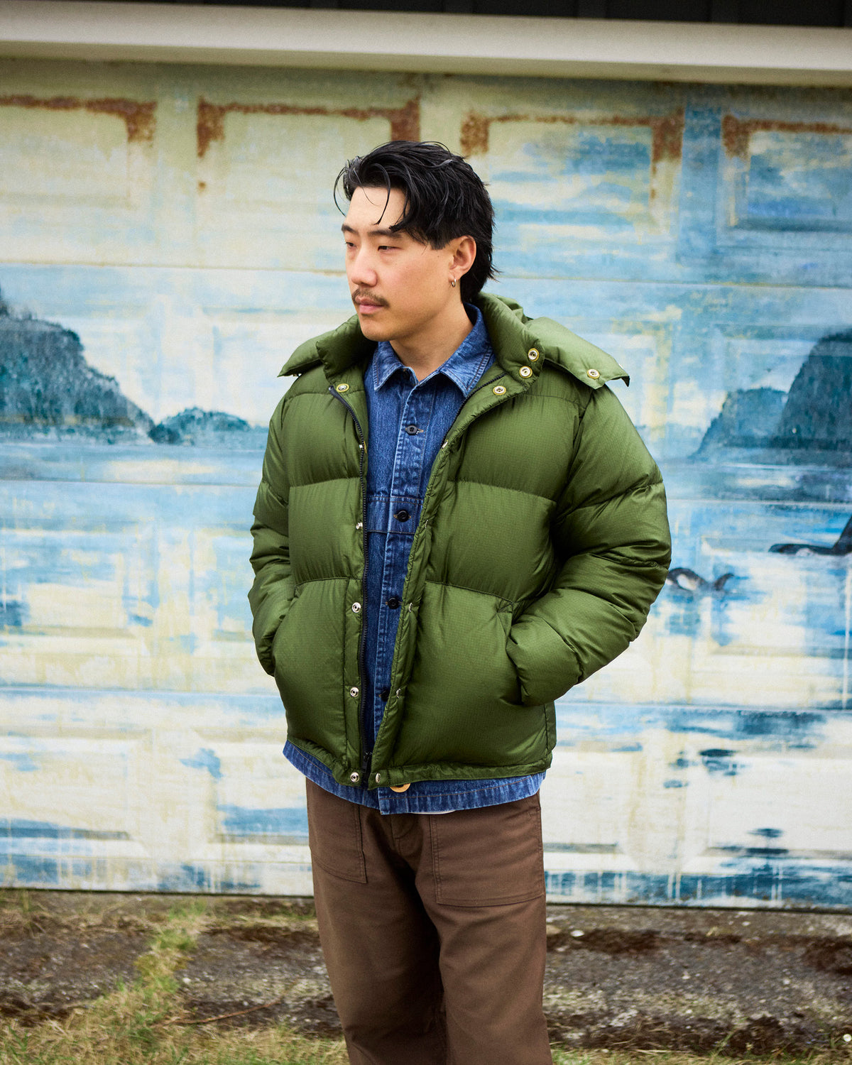 Olive green down sweater puffer jacket with quilted ripstop nylon and metallic button closures front view