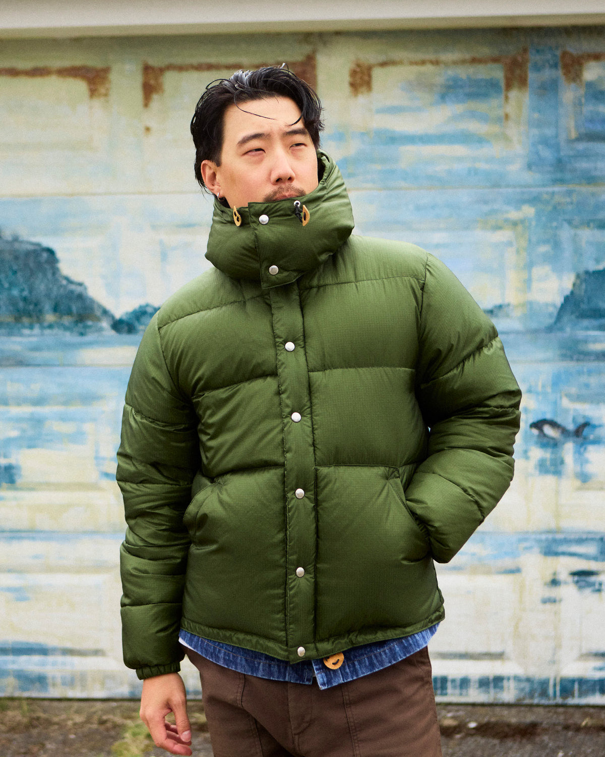 Olive green down sweater puffer jacket with high collar silver buttons made from ripstop nylon