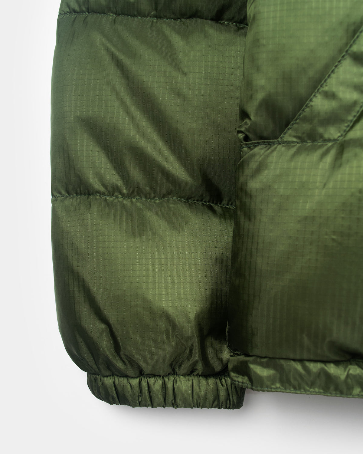 Olive green down sweater sleeve in ripstop nylon with quilted stitching and elasticated cuff