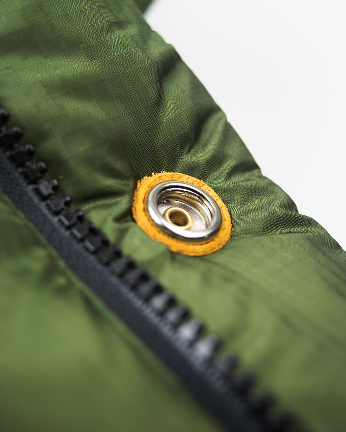 Olive green down sweater jacket with nylon ripstop fabric leather snap reinforcement and black zipper