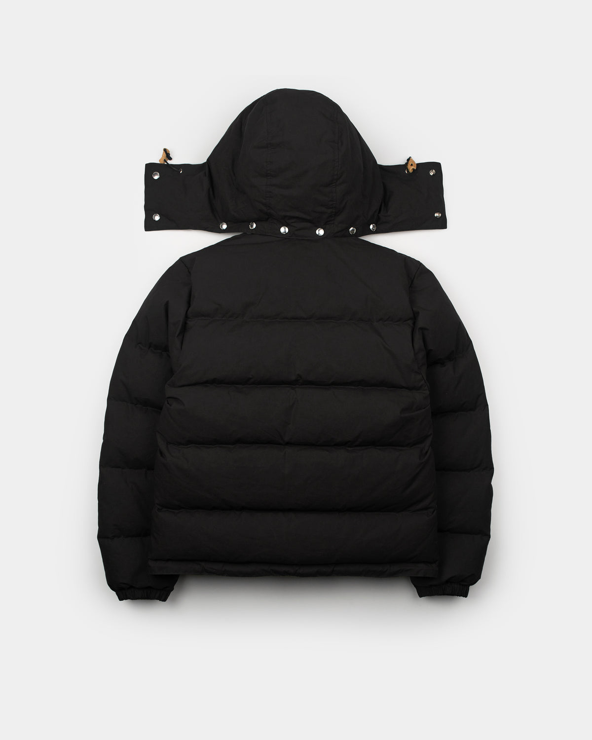 Black down sweater puffer jacket with hood silver snap buttons and adjustable straps made of dry wax cotton