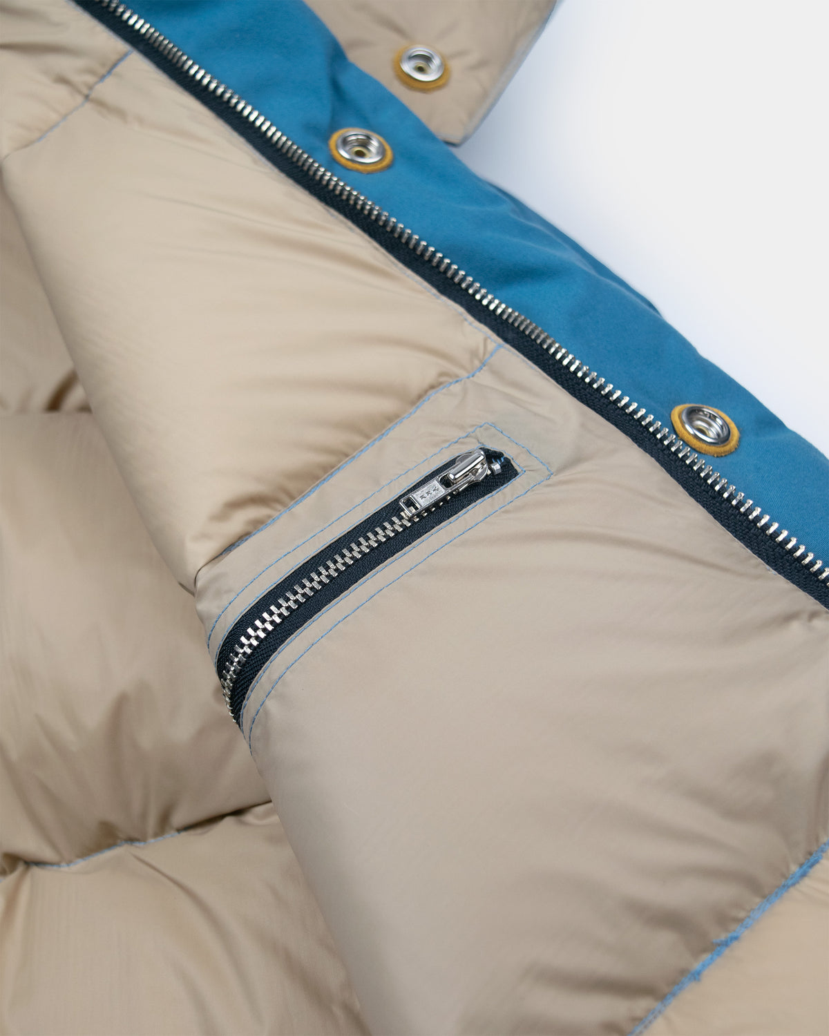 Down sweater puffer jacket with leather snap reinforcement made from dry wax cotton robin's blue