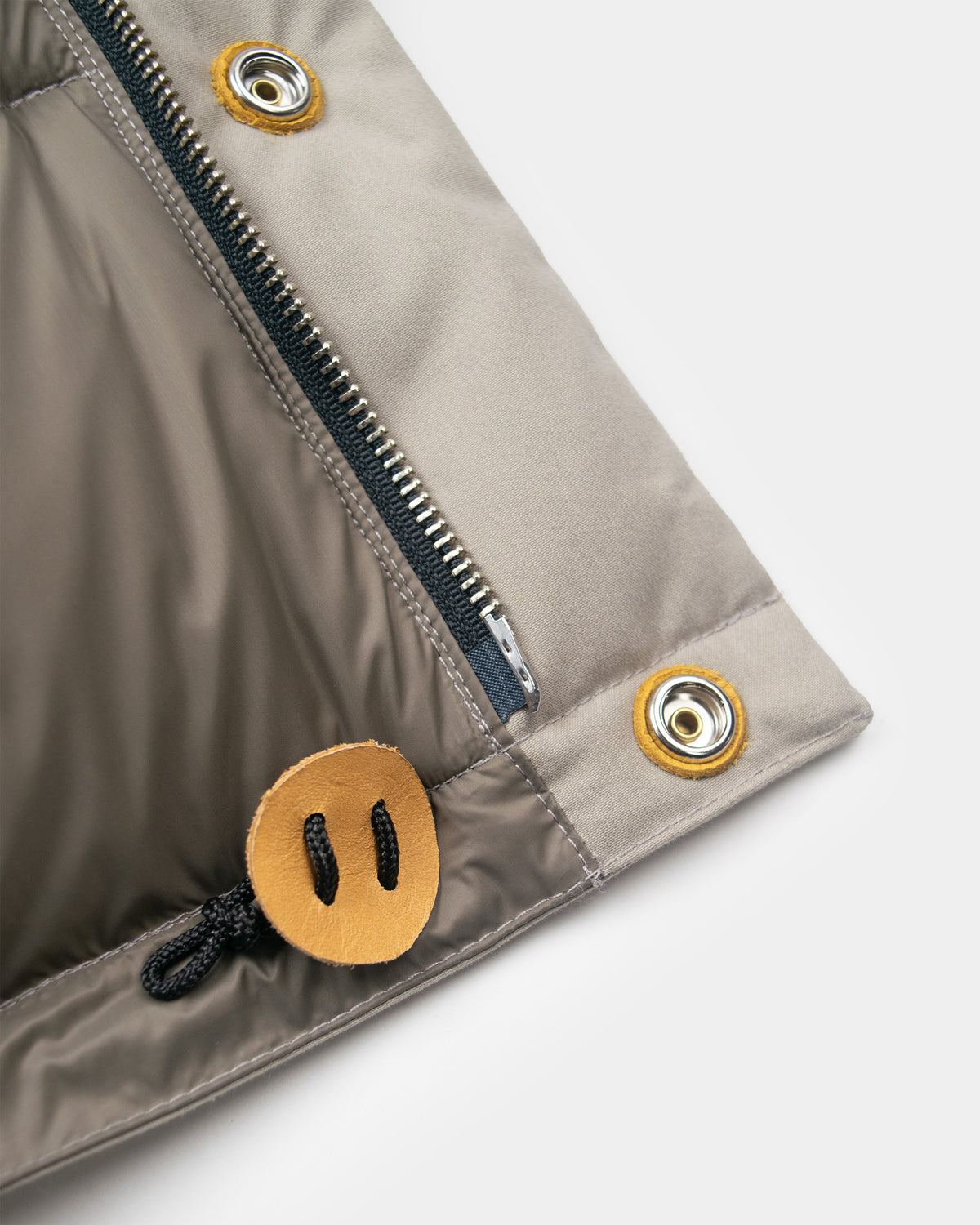 Quilted down sweater in dry wax cotton stone with Silver zipper and leather toggle