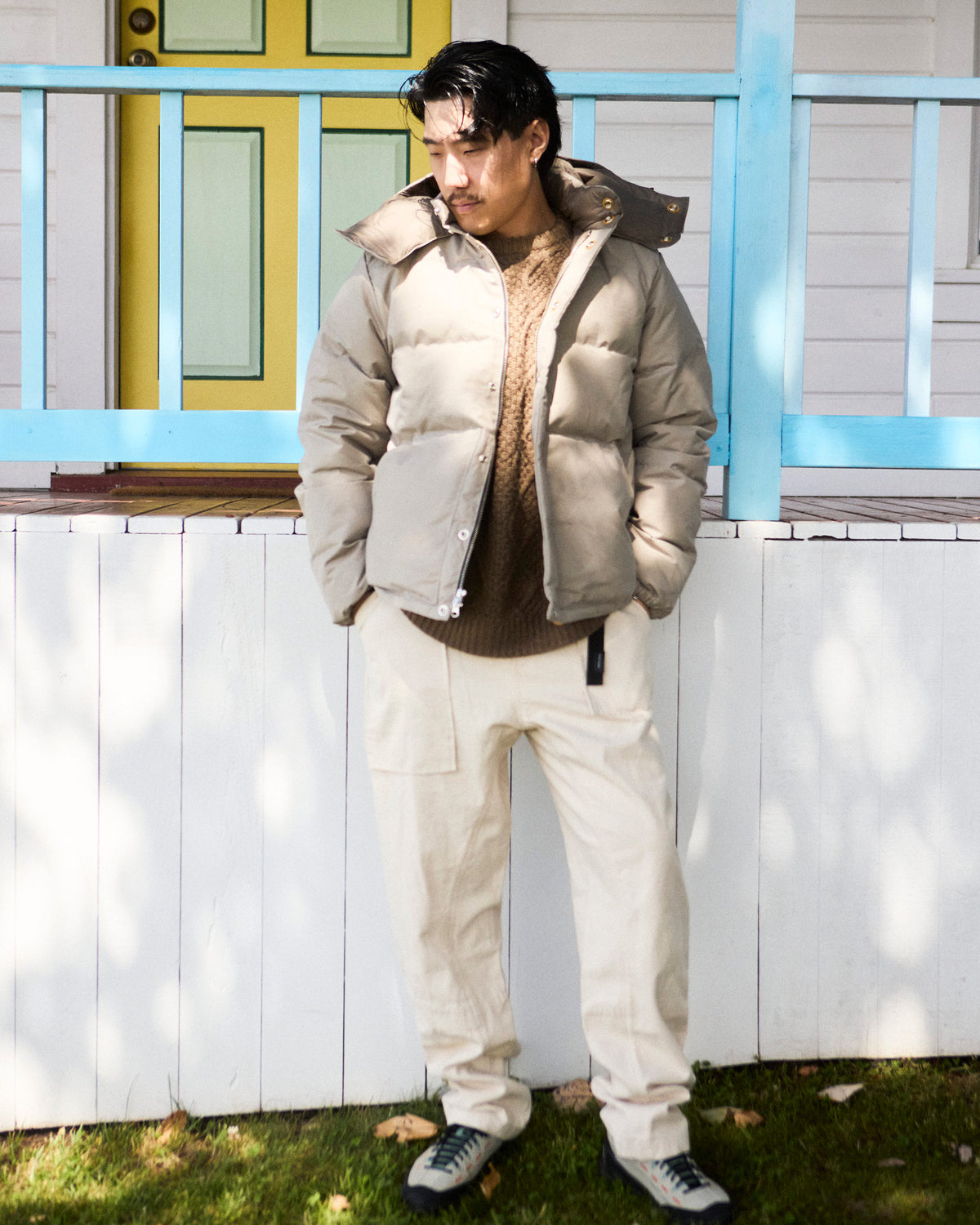 Down sweater puffer jacket with hood and button closure made from dry wax cotton stone color