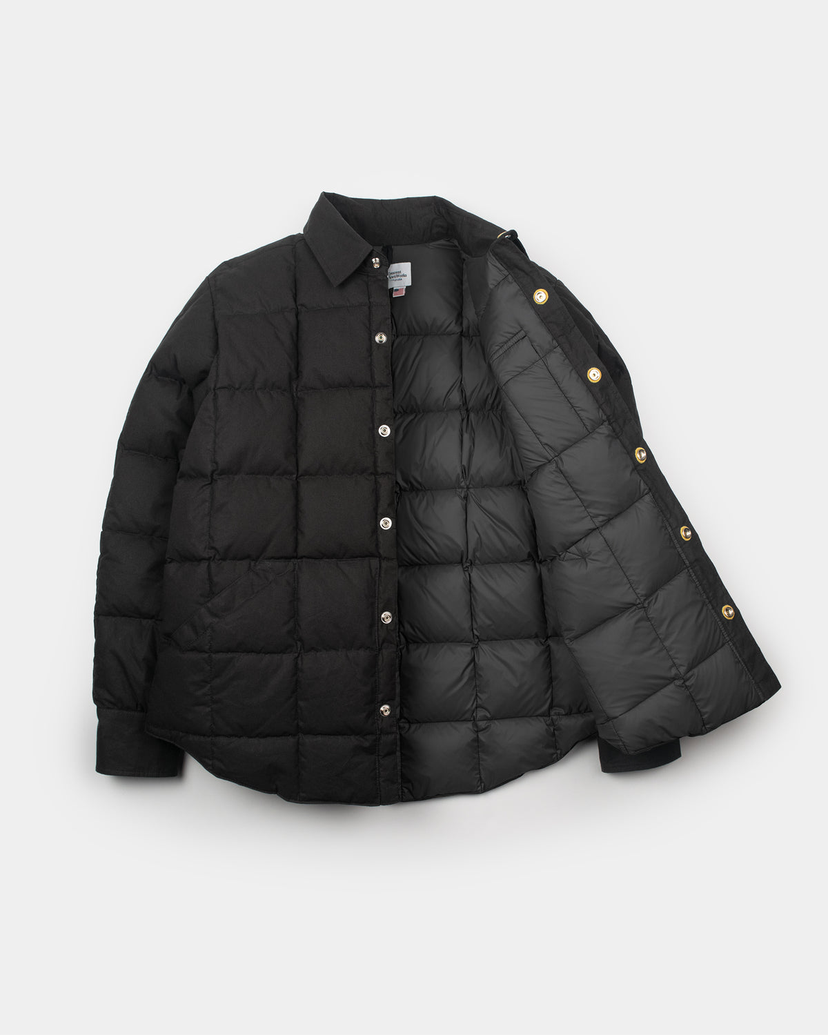 Black quilted puffer down shirt jacket with leather snap reinforcement collar made from dry wax cotton