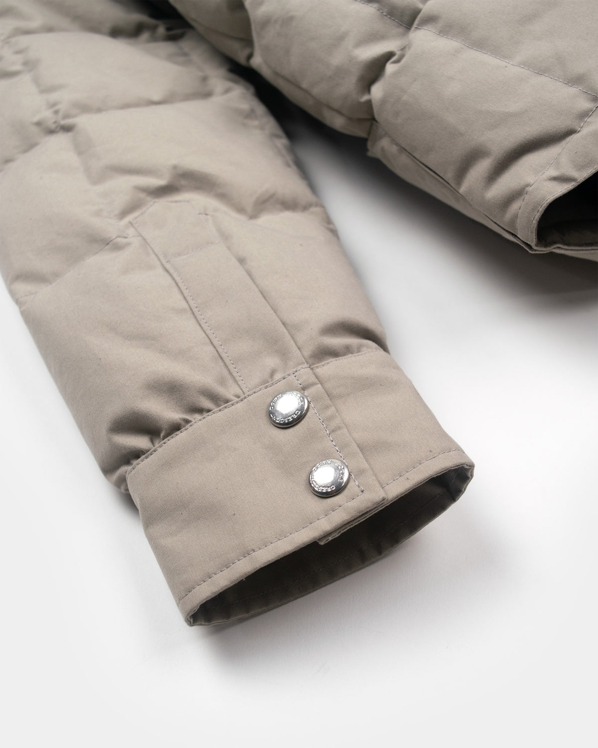 Stone quilted puffer jacket sleeve with silver-toned snap buttons in down shirt dry wax cotton stone