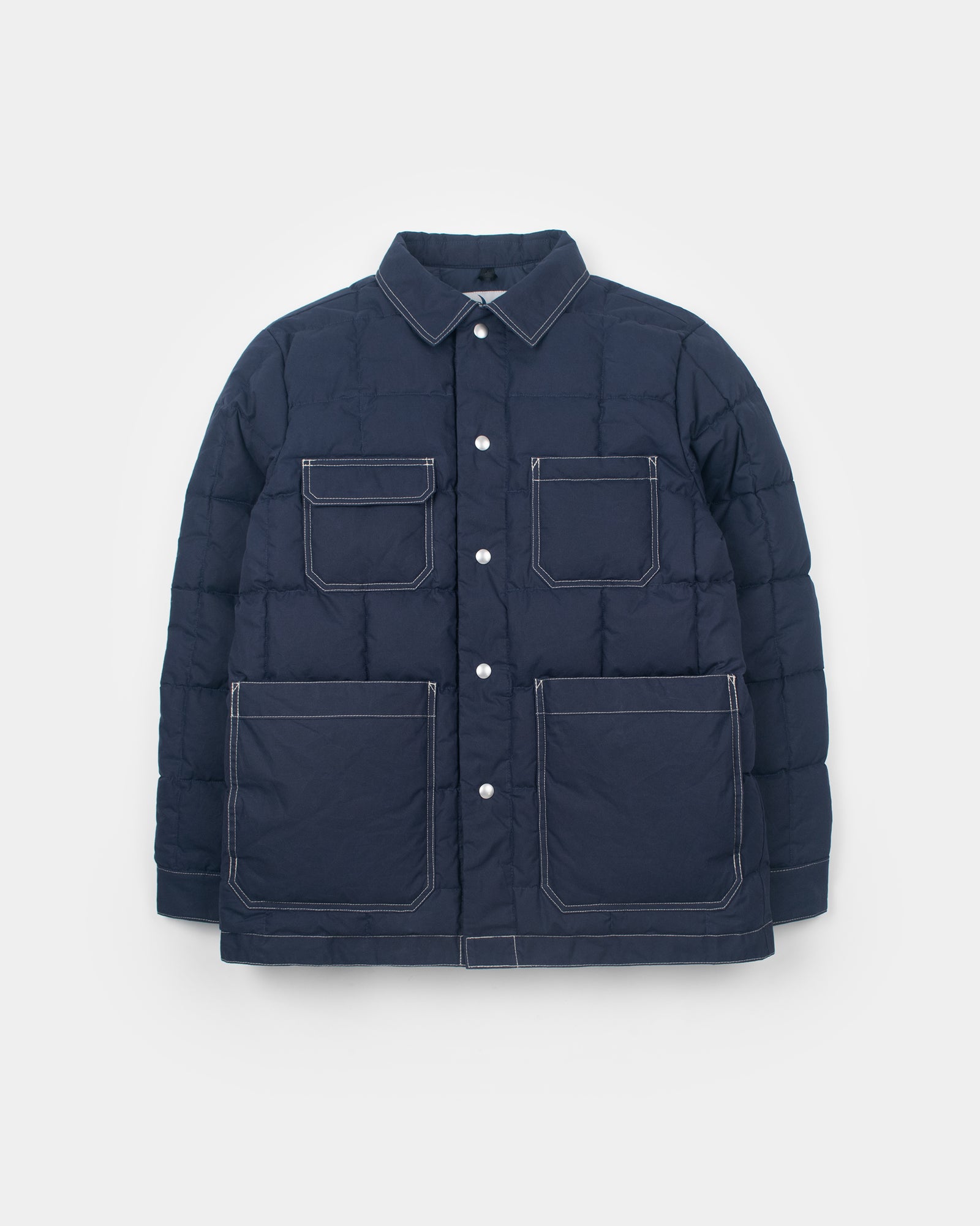 A navy blue Down Chore Coat jacket with cream contrast stitching, featuring a pointed collar, a snap-button front, and four large front pockets, displayed on a light gray background.