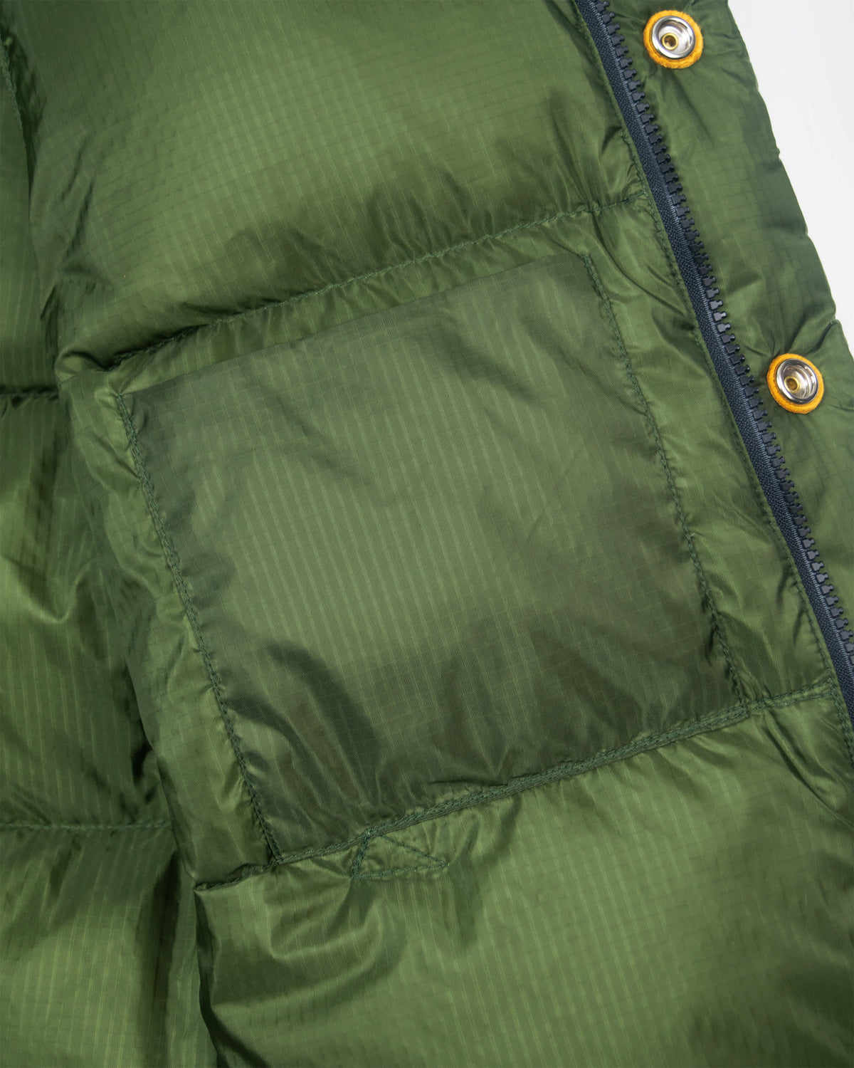 Olive green down italian vest with ribbed ripstop nylon texture and leather snap reinforcement 