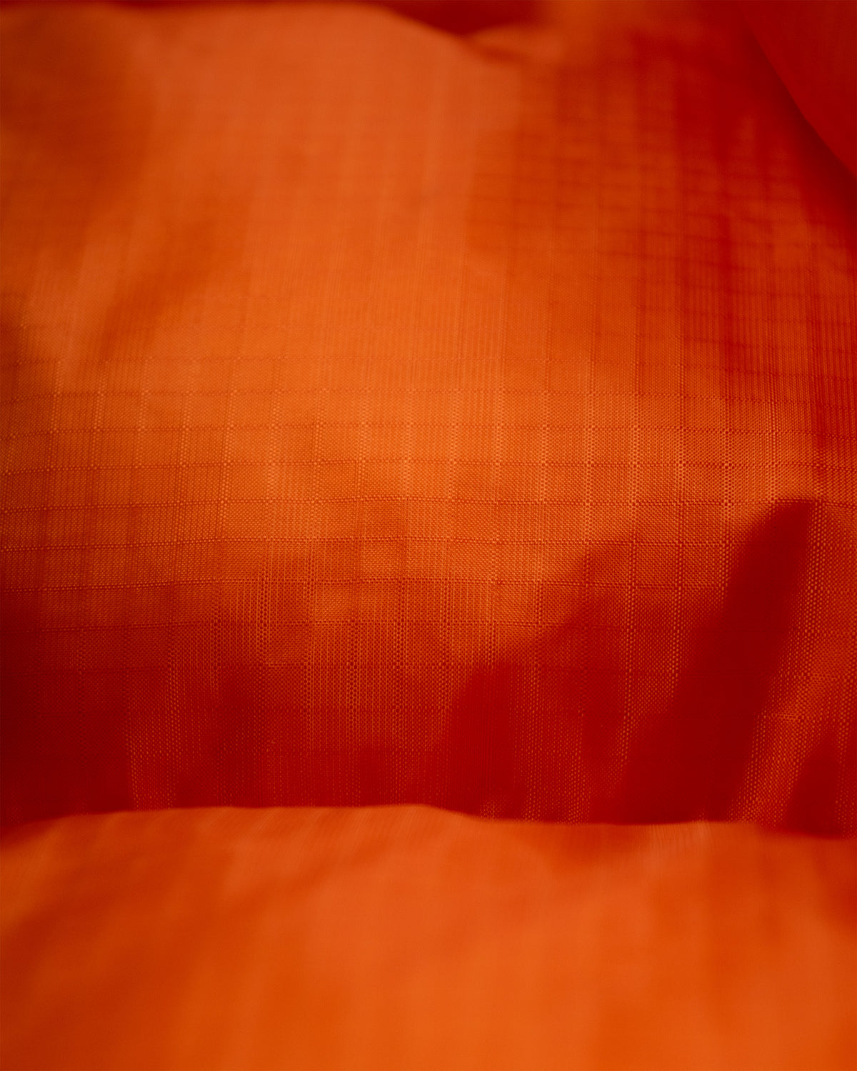 Orange textured down italian vest made from ripstop nylon for lightweight durable warmth