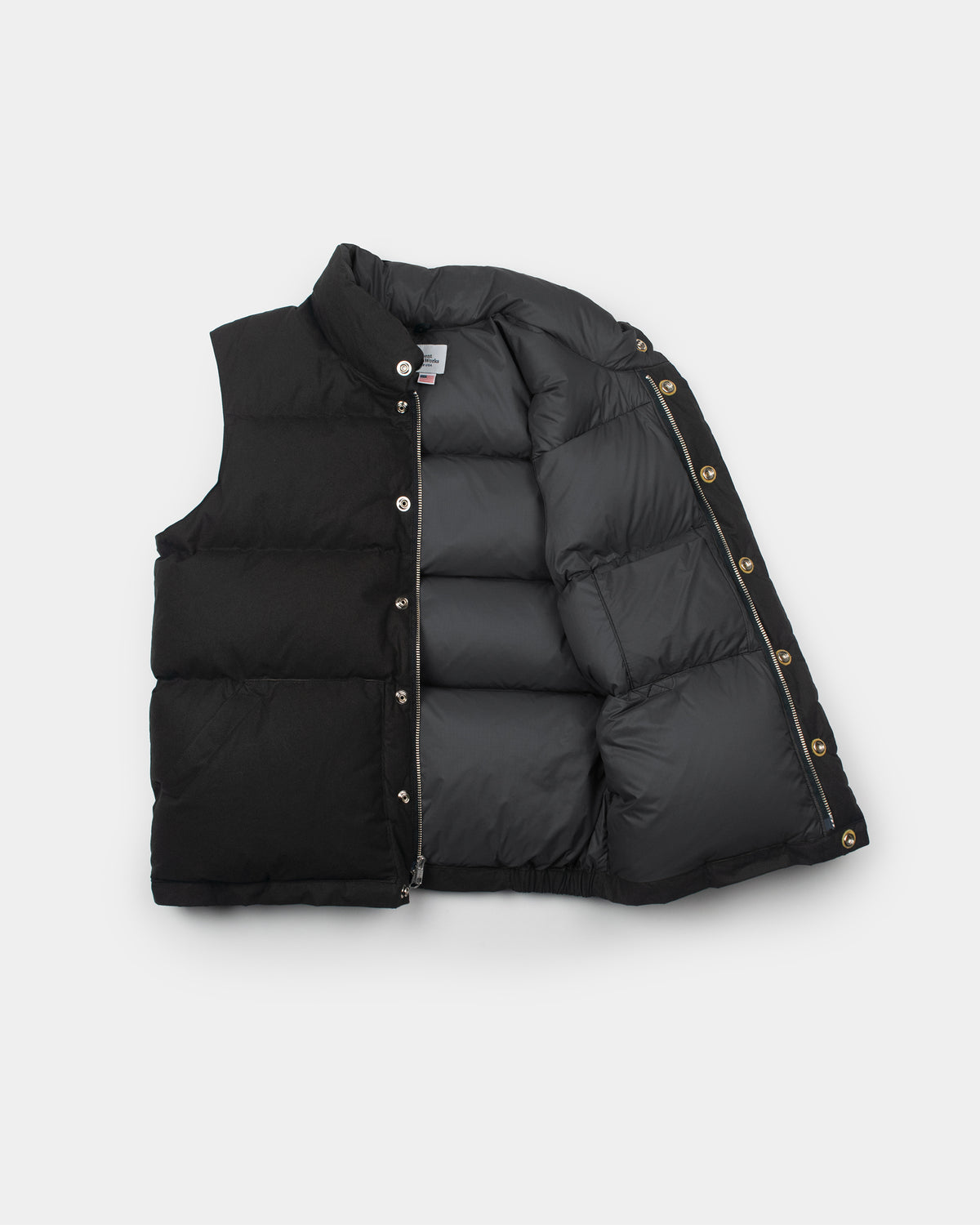 Black down Italian vest in dry wax cotton with quilted panels silver buttons and zipper accents