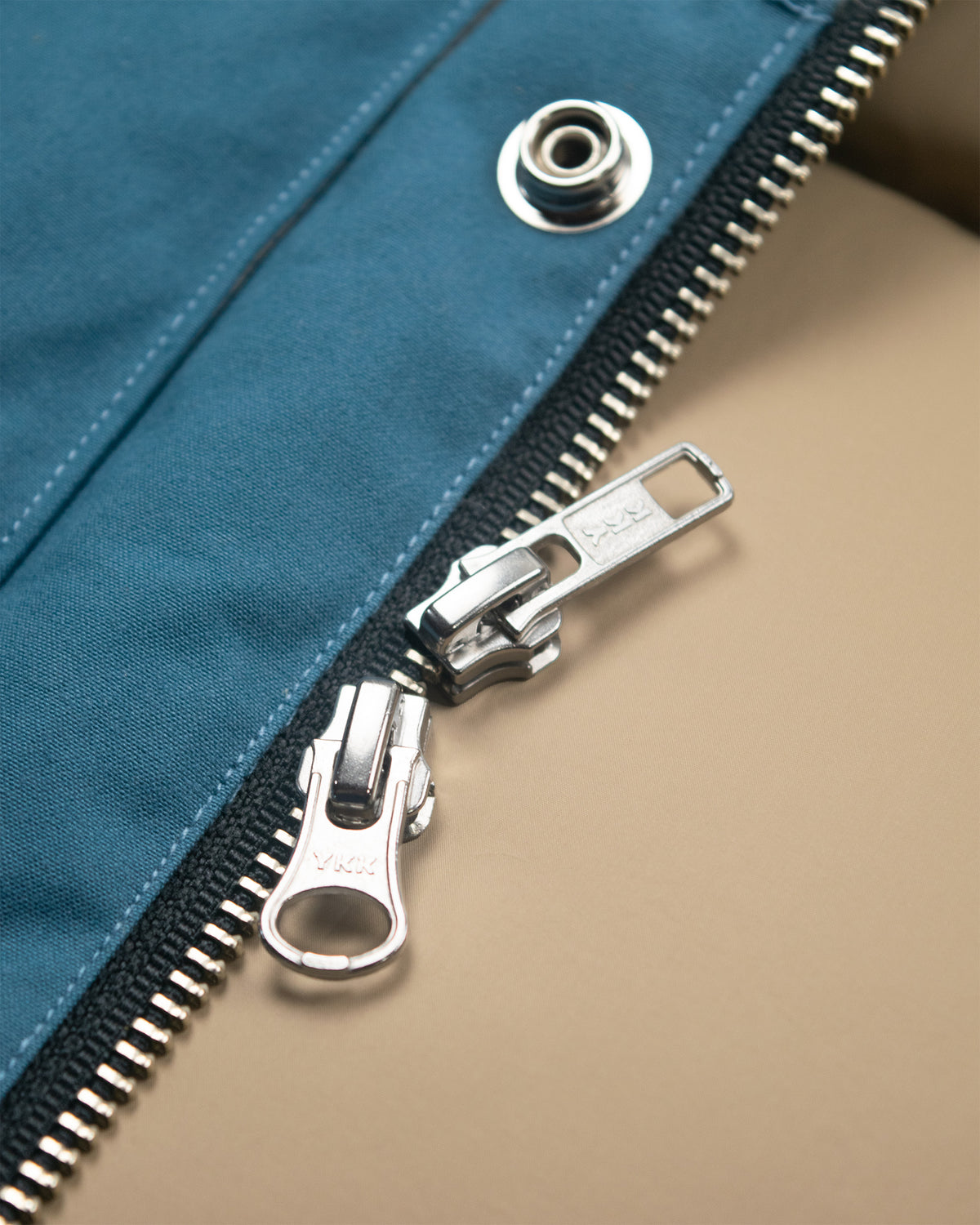 Silver-toned ykk zipper with metallic pull tab on robin's blue dry wax cotton down italian vest