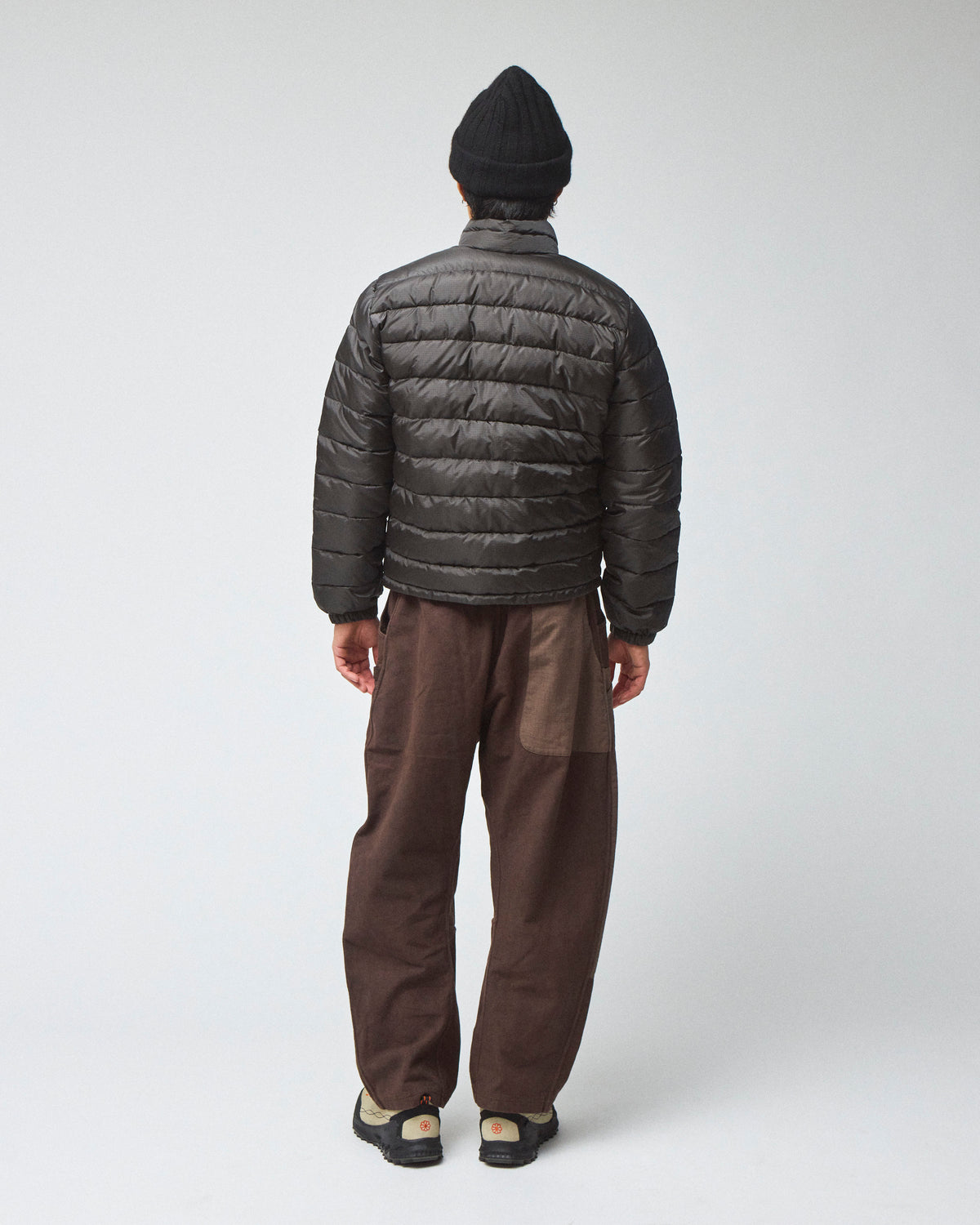 Model wearing a Seattle Jacket in Charcoal,  a view of the back 
