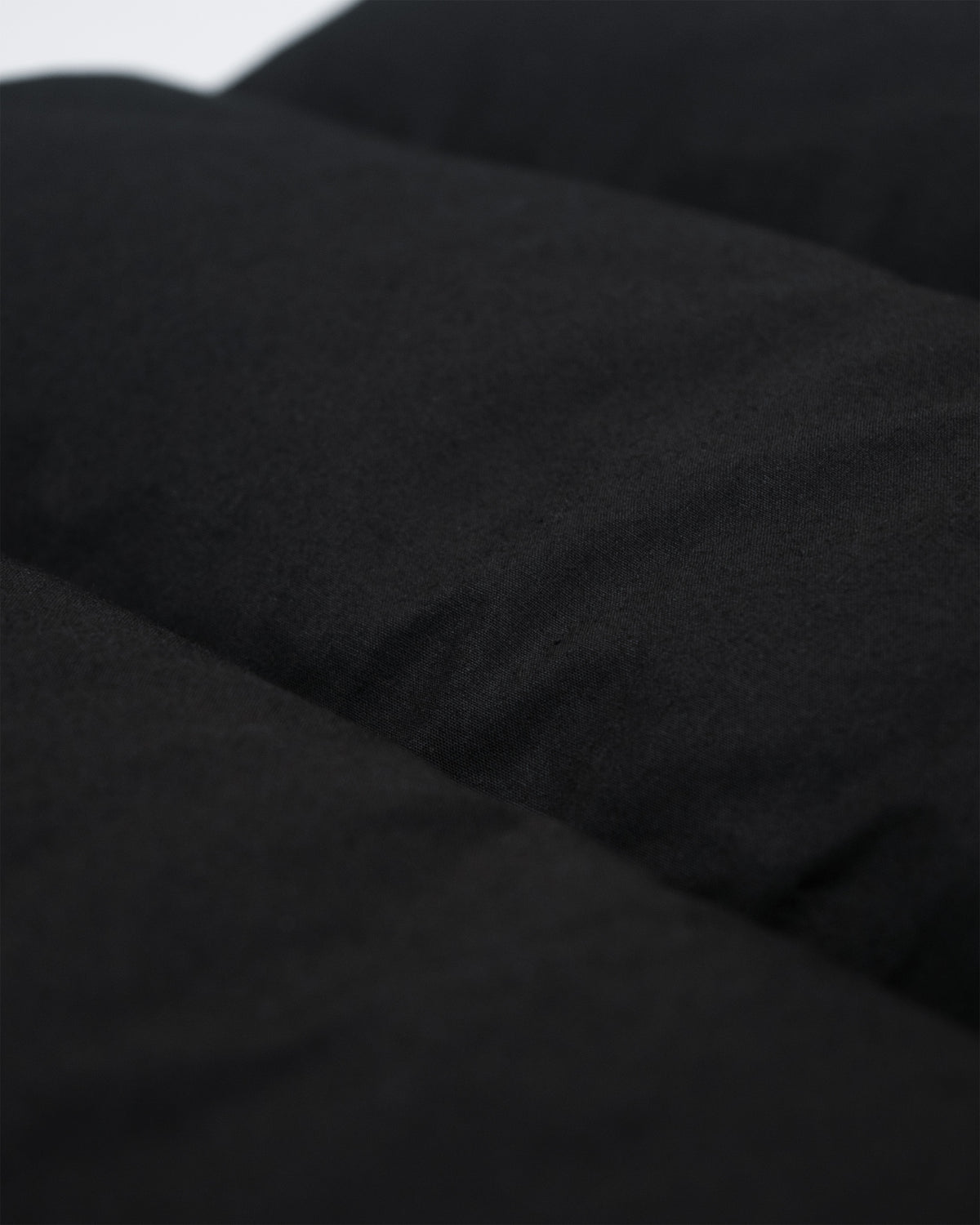 Black quilted dry wax cotton fabric with a soft textured surface from the north by northwest vest