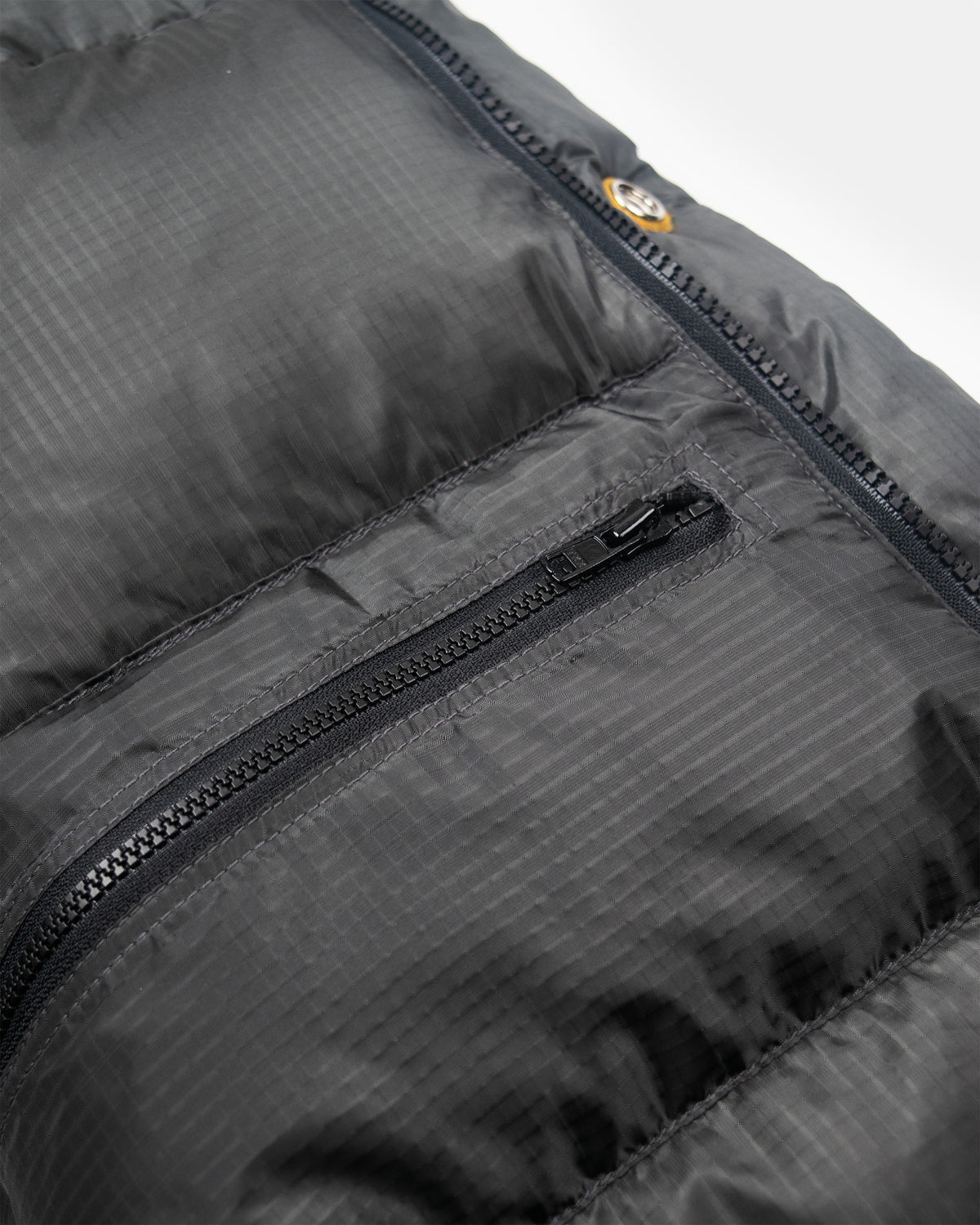 Classico down parka in charcoal ripstop nylon with quilted puffer texture and black zipper details visible