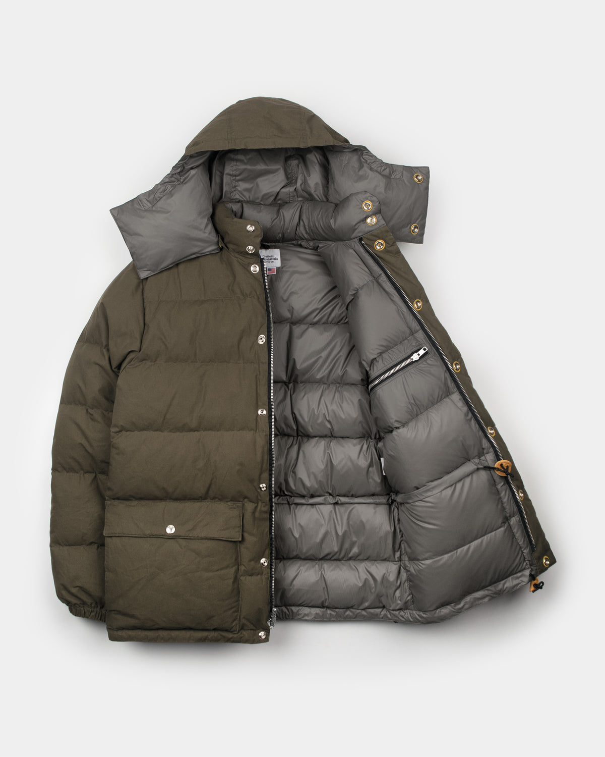 Tent green quilted down parka with detachable hood silver snap buttons made of dry waxed cotton