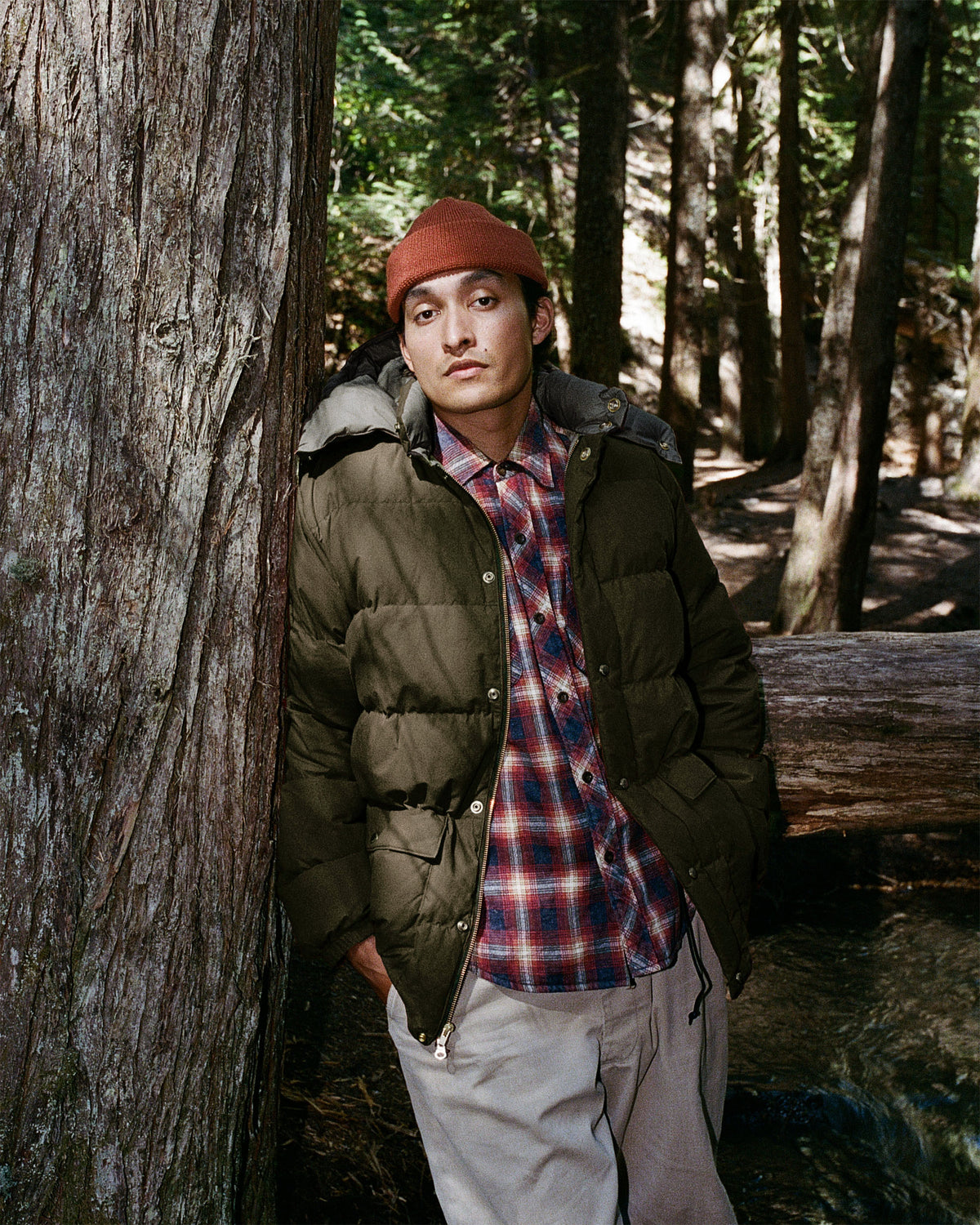 A man wearing a classico down parka in dry waxed cotton with tent green color 