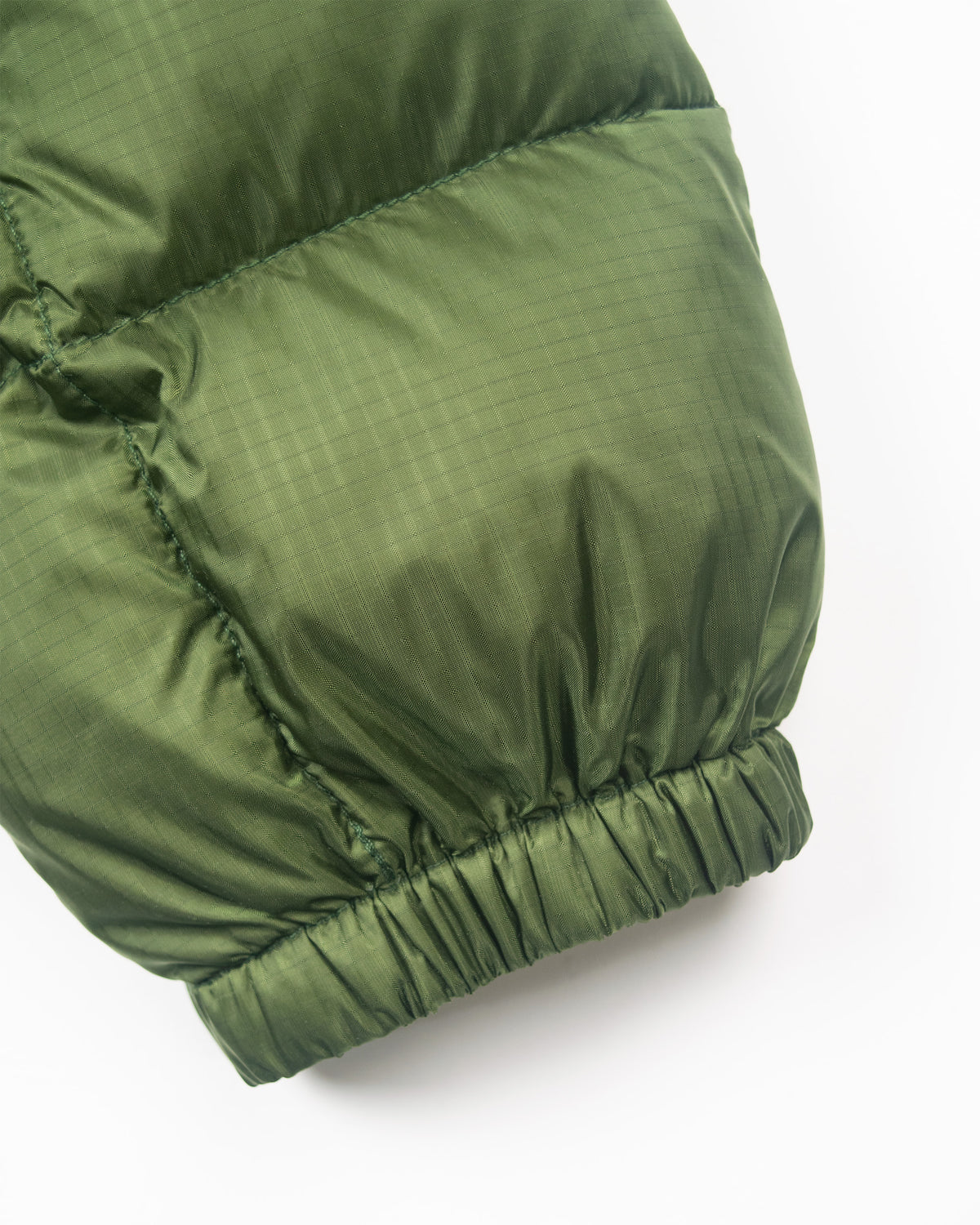 Olive green hooded sweatshirt sleeve in ripstop nylon with quilted stitching and elasticated cuff