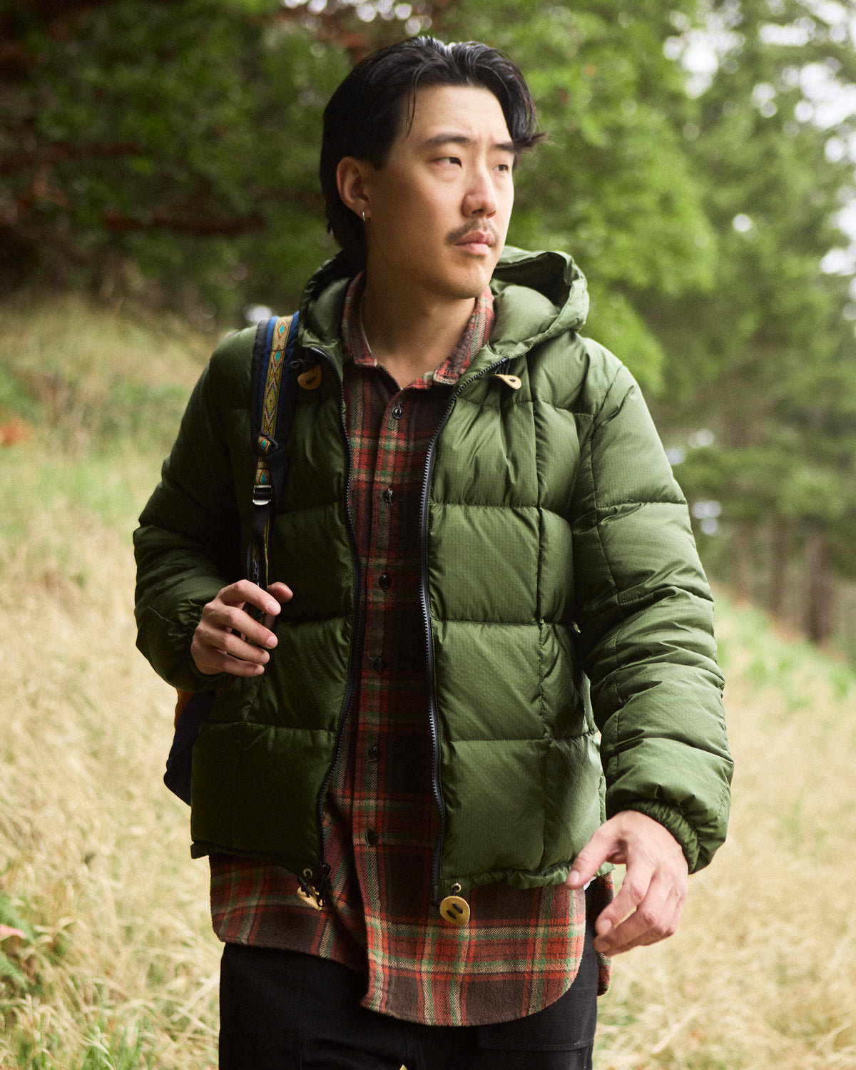 Olive green puffer jacket with quilted design leather toggle closures made of ripstop nylon hooded sweatshirt