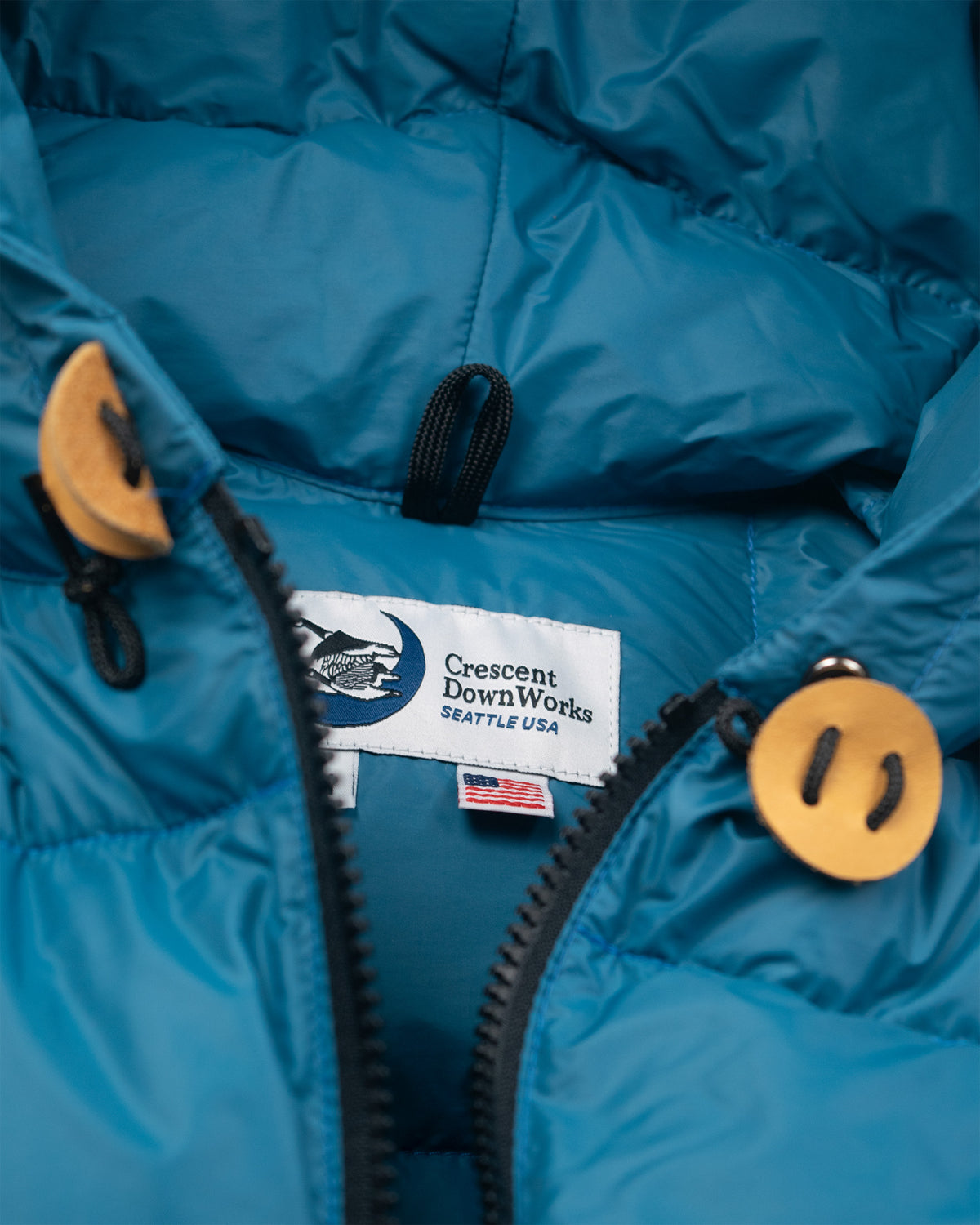 Blue hooded sweatshirt made of nylon with leather toggles and crescent downworks label 