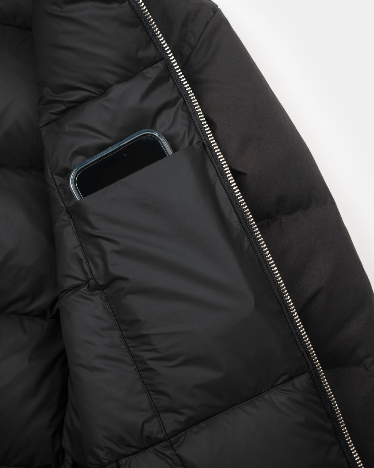Black hooded sweatshirt made from dry wax cotton featuring a quilted puffer design and silver zipper