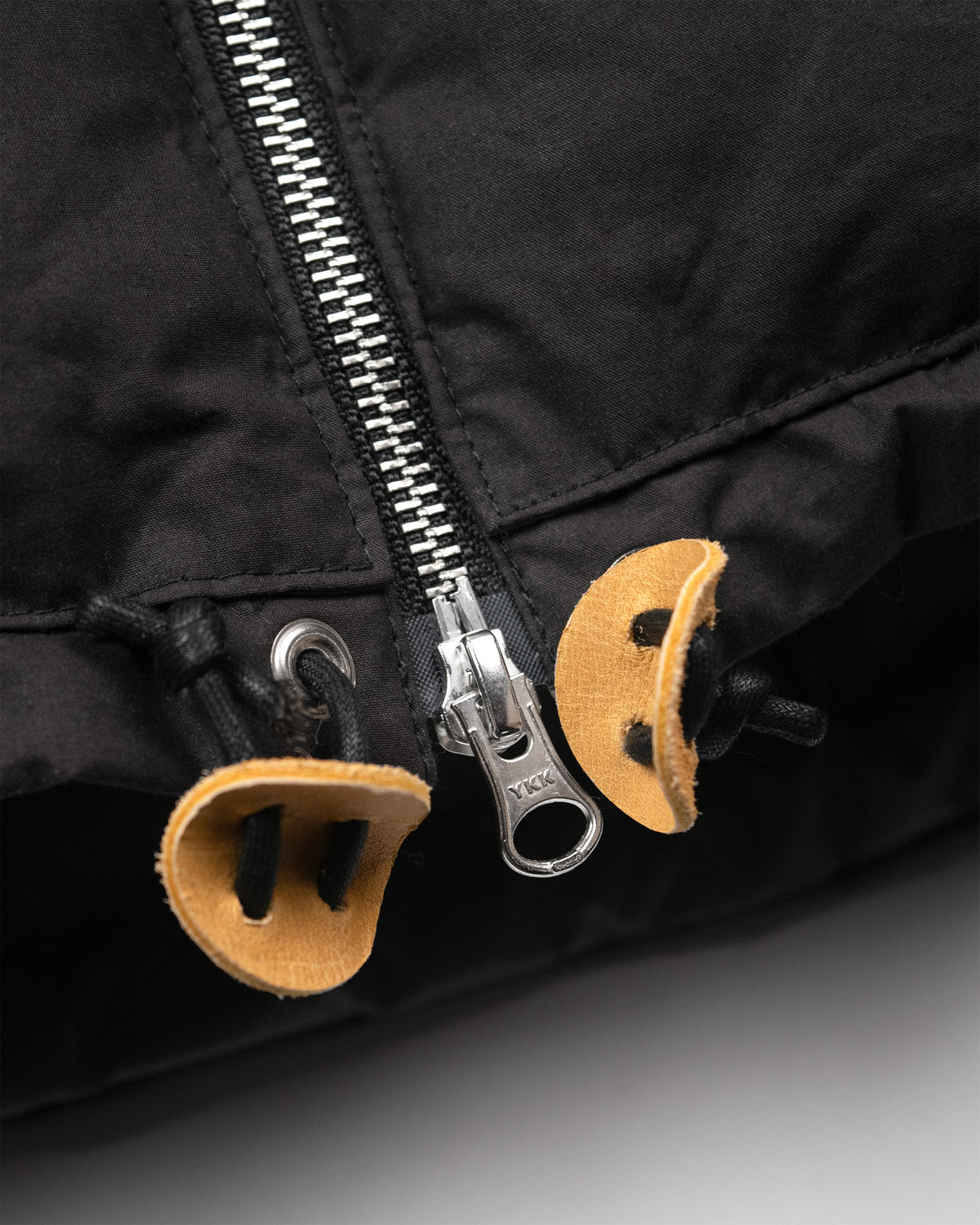 Black hooded sweatshirt in dry wax cotton with silver ykk zipper and leather toggles