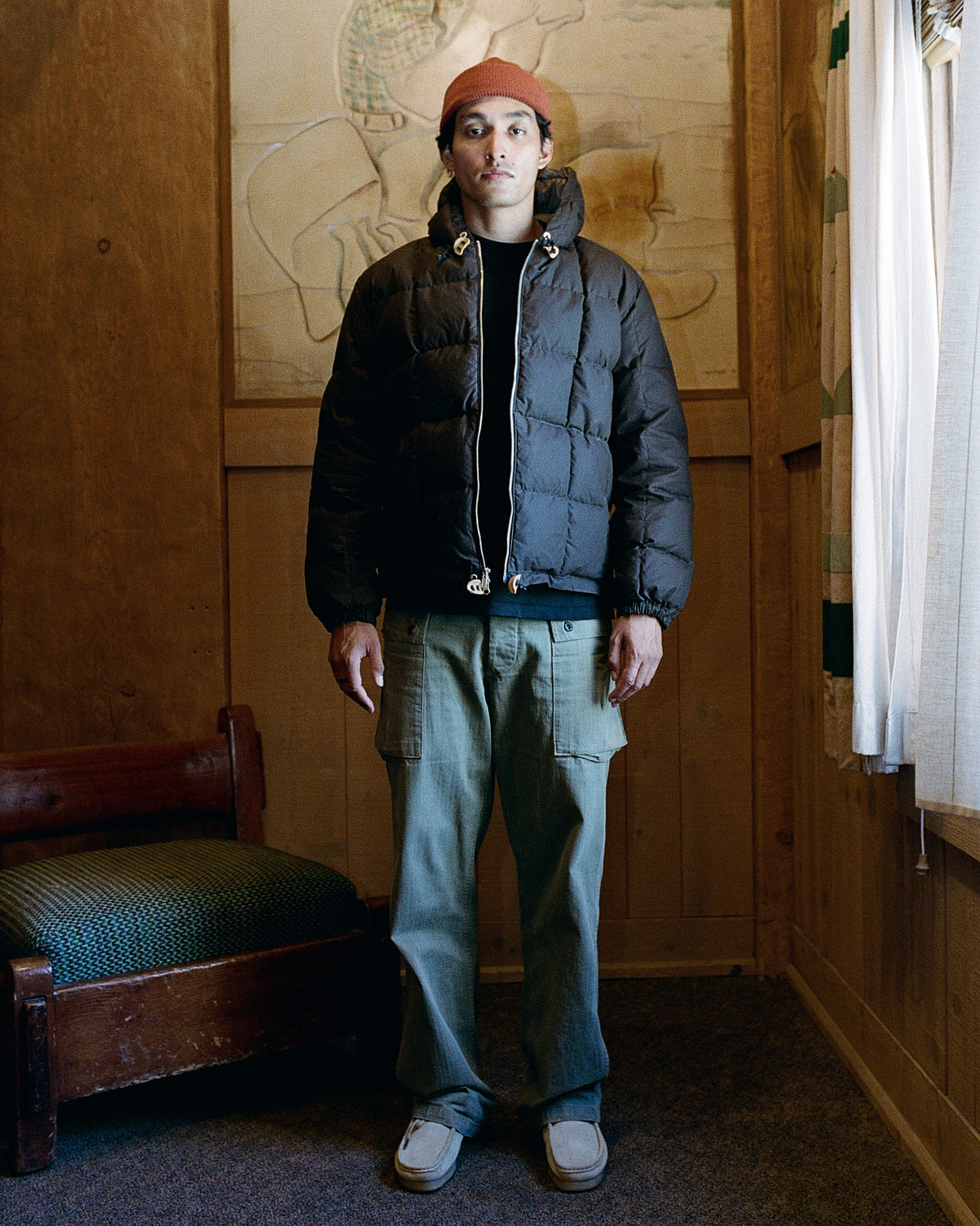 Black quilted puffer jacket with hood and silver zipper pulls made from dry wax cotton 