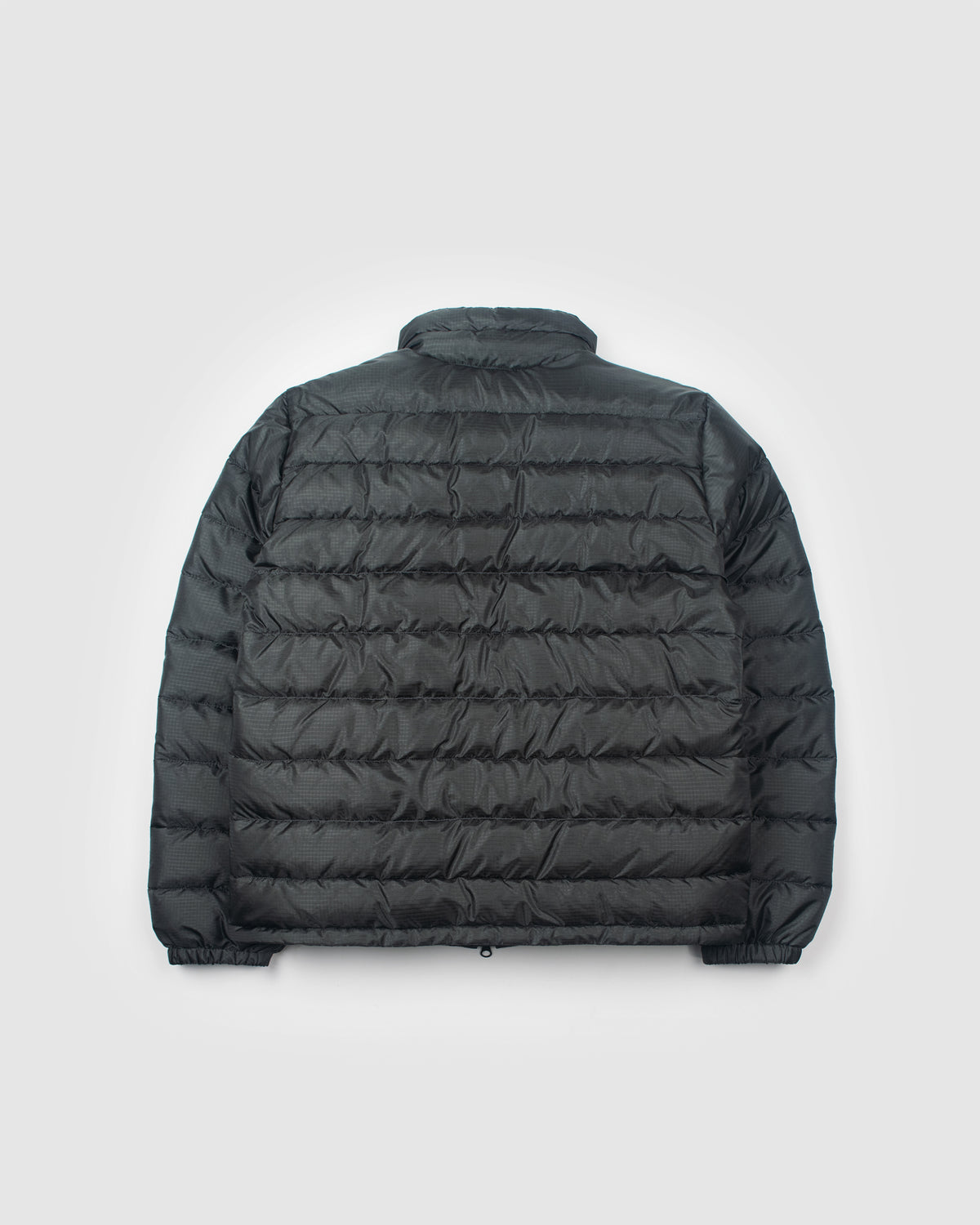 A charcoal Seattle Liner jacket with horizontal quilting, laid flat against a light gray background.