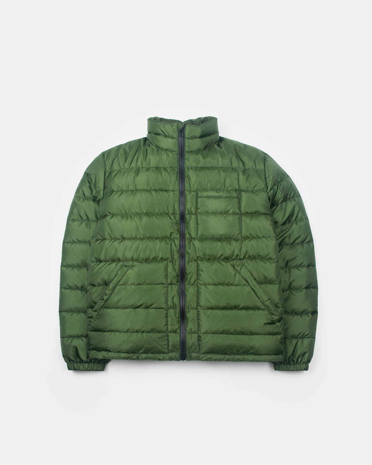 A green Seattle Liner jacket with horizontal quilting, laid flat against a light gray background.