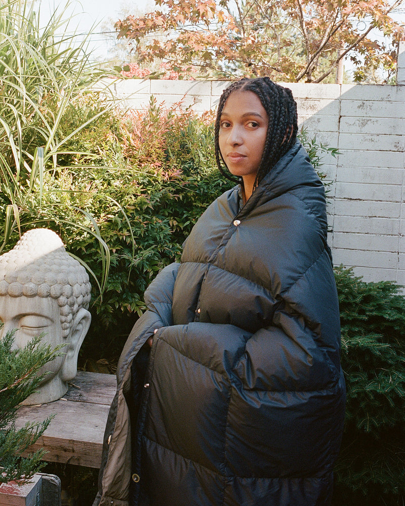 2000 Female Model wearing black side of Down Snap Blanket