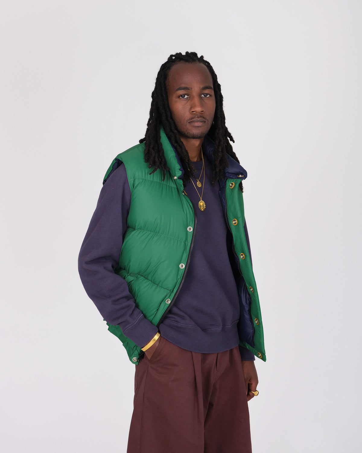 Model wearing the Crescent Down Works &quot;Green&quot; colorway of the Italian Vest. 
