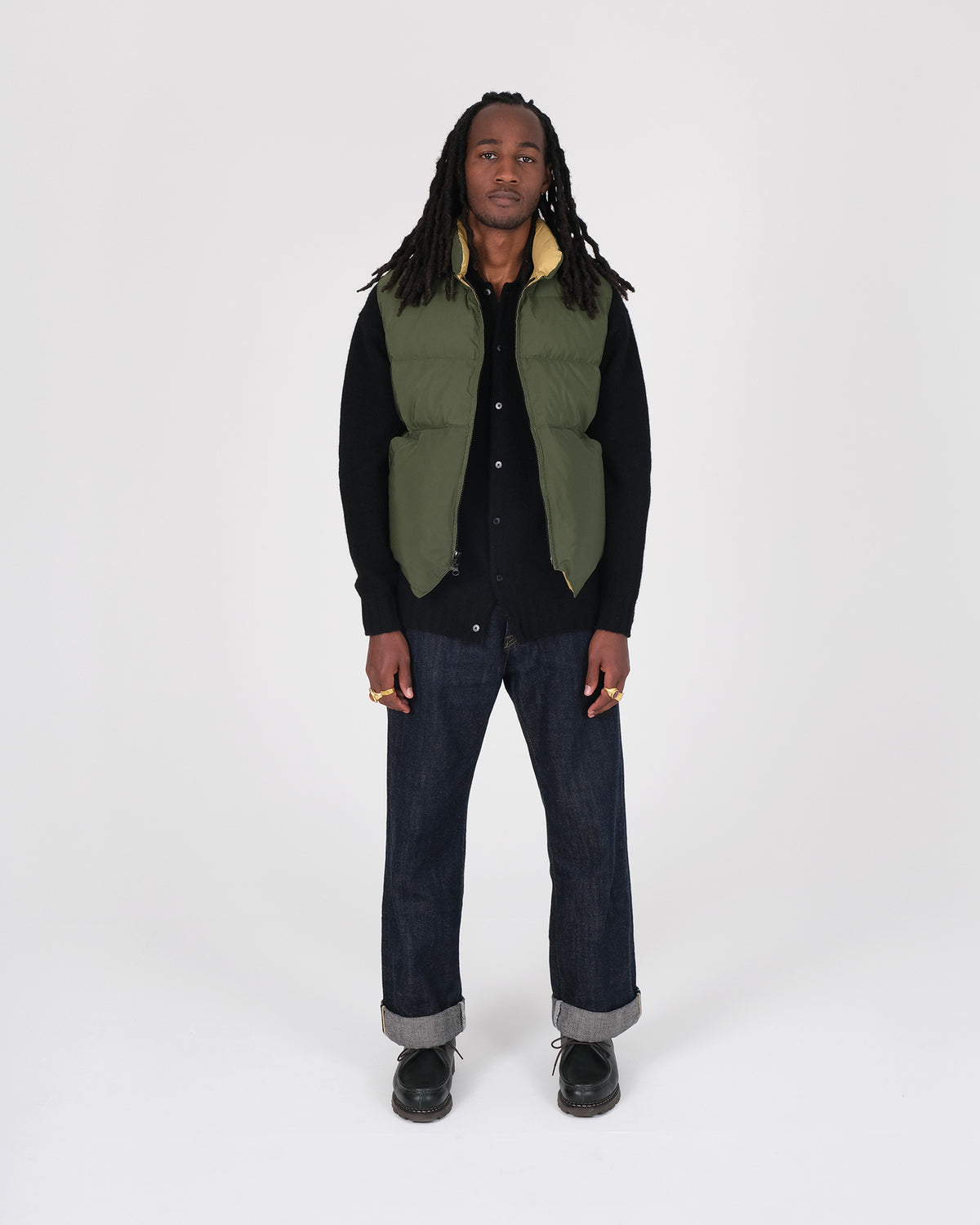 Model wearing the Crescent Down Works &quot;Olive&quot; colorway of the North by Northwest vest. 