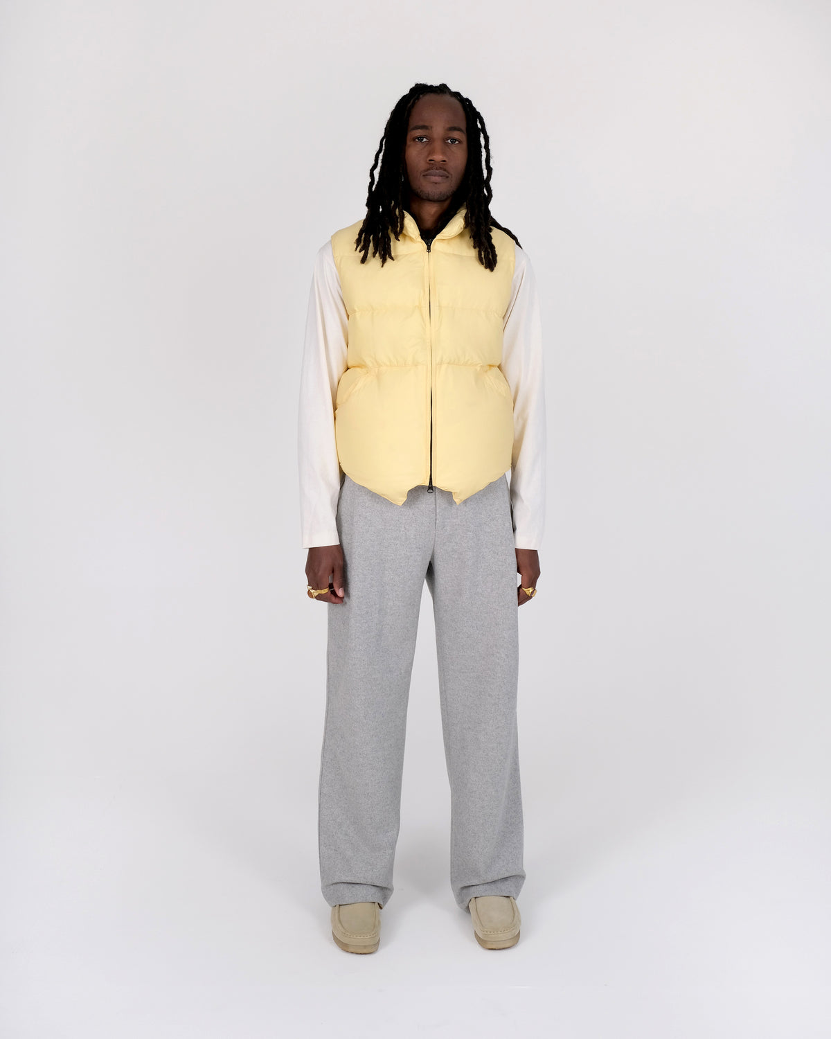 Front view of a model wearing the Crescent Down Works &quot;Sun&quot; colorway of the Down North by Northwest vest. 