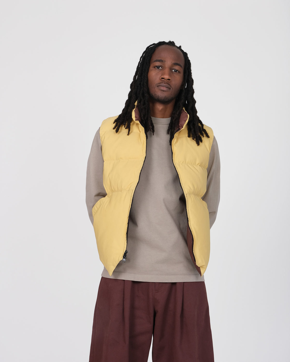 Model wearing the Crescent Down Works &quot;Butter&quot; colorway of the North by Northwest vest. 